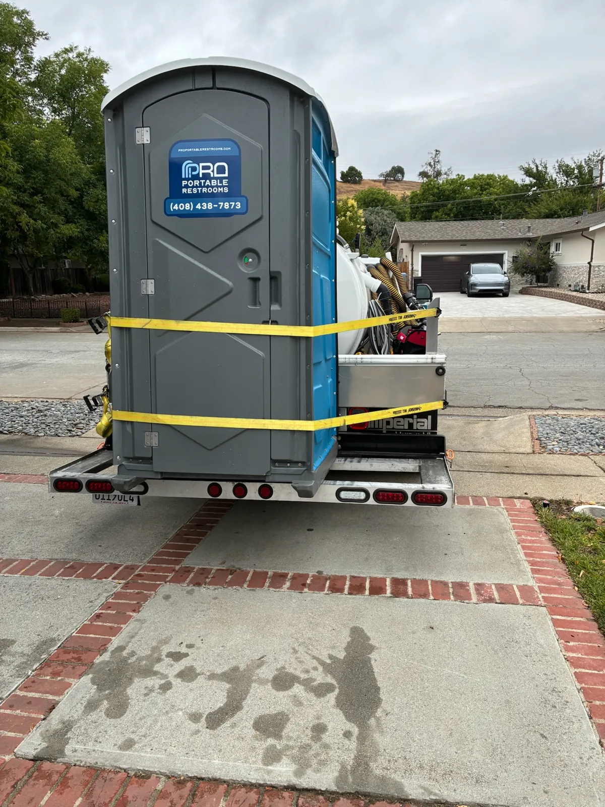 A Pro Portable Restrooms unit strapped on the trailer for delivery