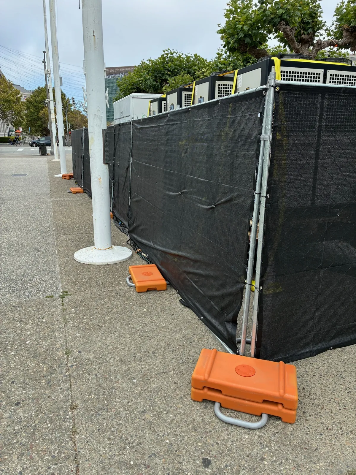 A black privacy screen temporary fence installed by a marina