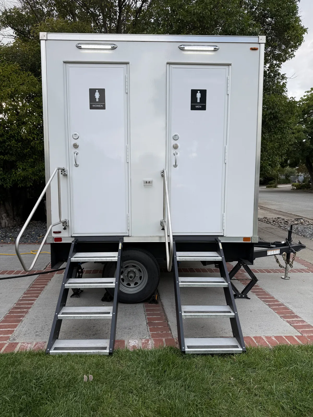 A Pro Portable Restrooms luxury restroom trailer staged on a transport trailer for delivery