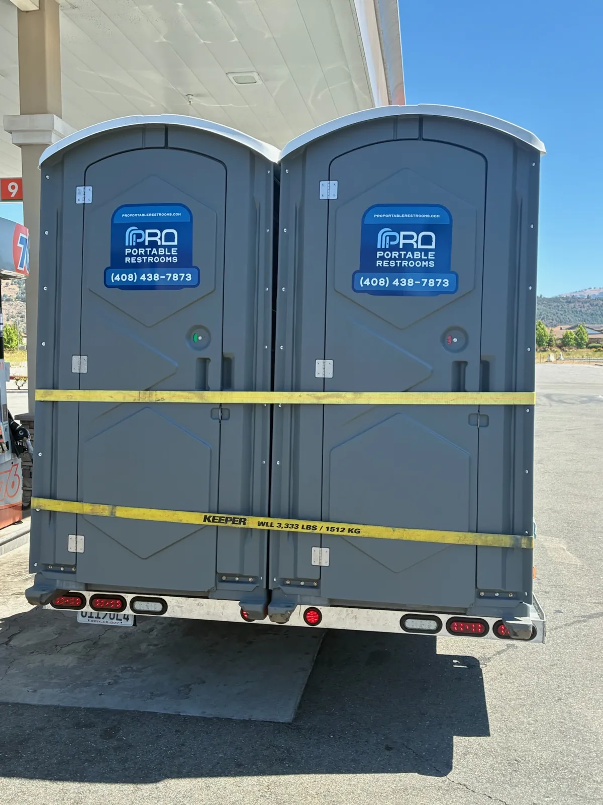 Two Pro Portable Restrooms units loaded on a delivery trailer