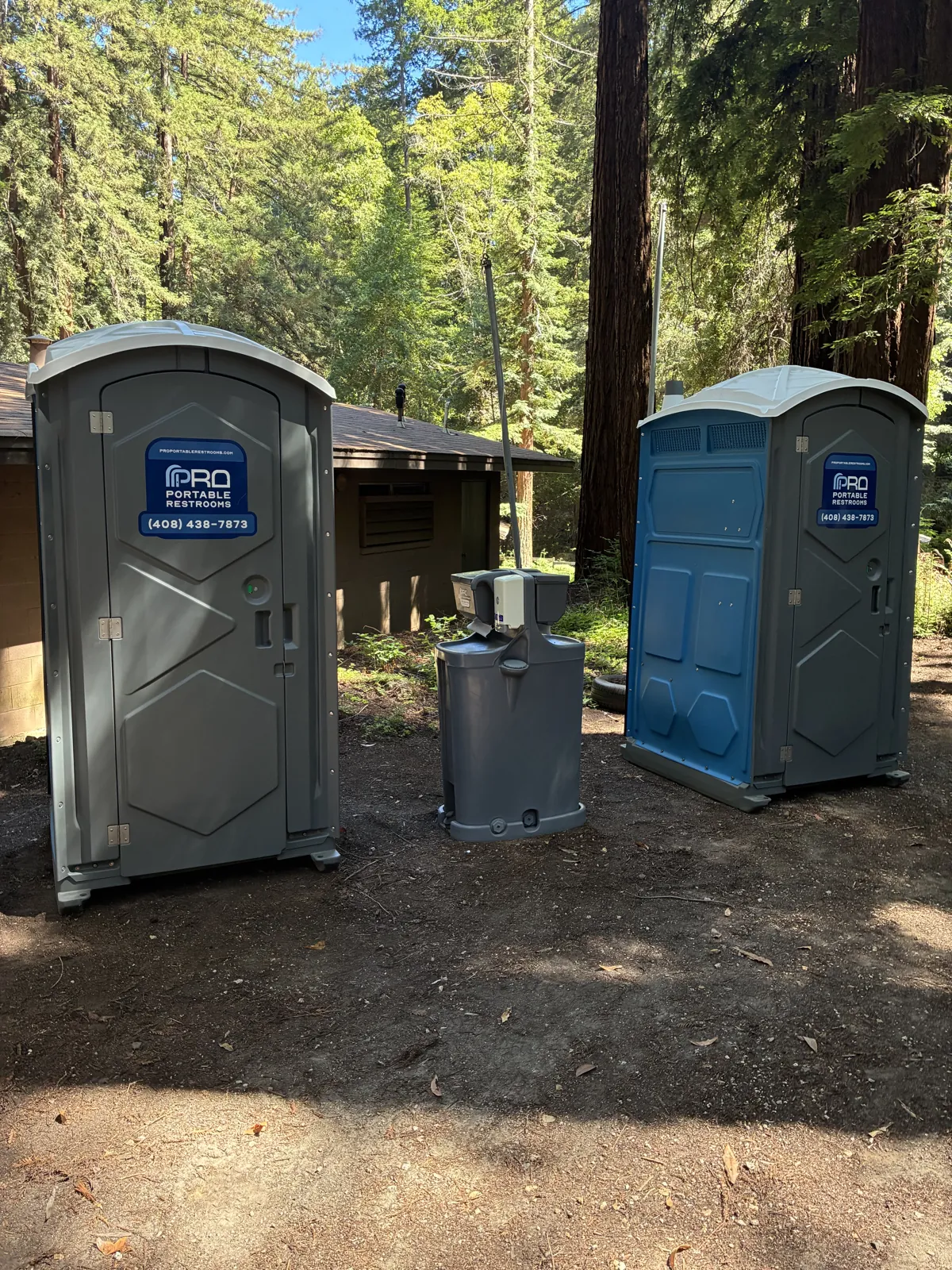 Two Pro Portable Restrooms units set up at a wooded rural site