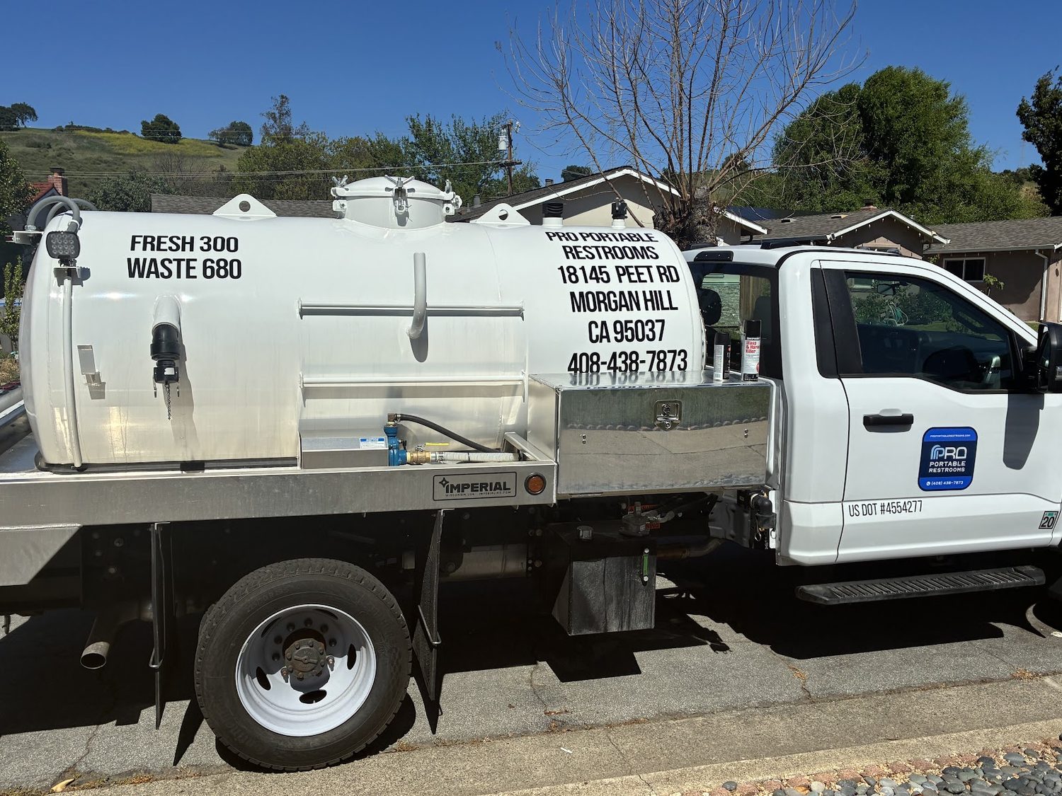 A Pro Portable Restrooms branded service and pump truck
