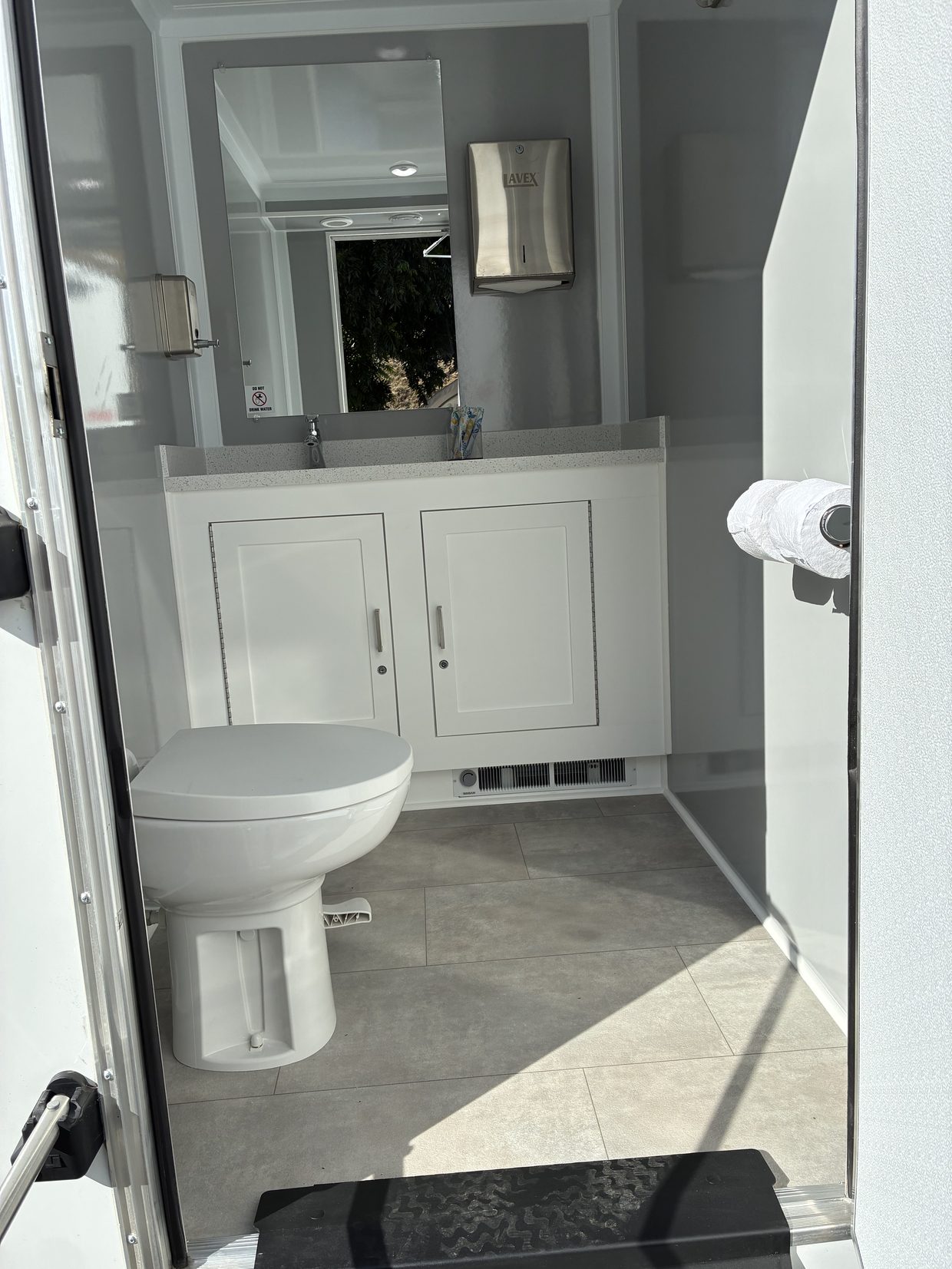 The finished interior of a luxury restroom trailer with running water sinks and premium amenities