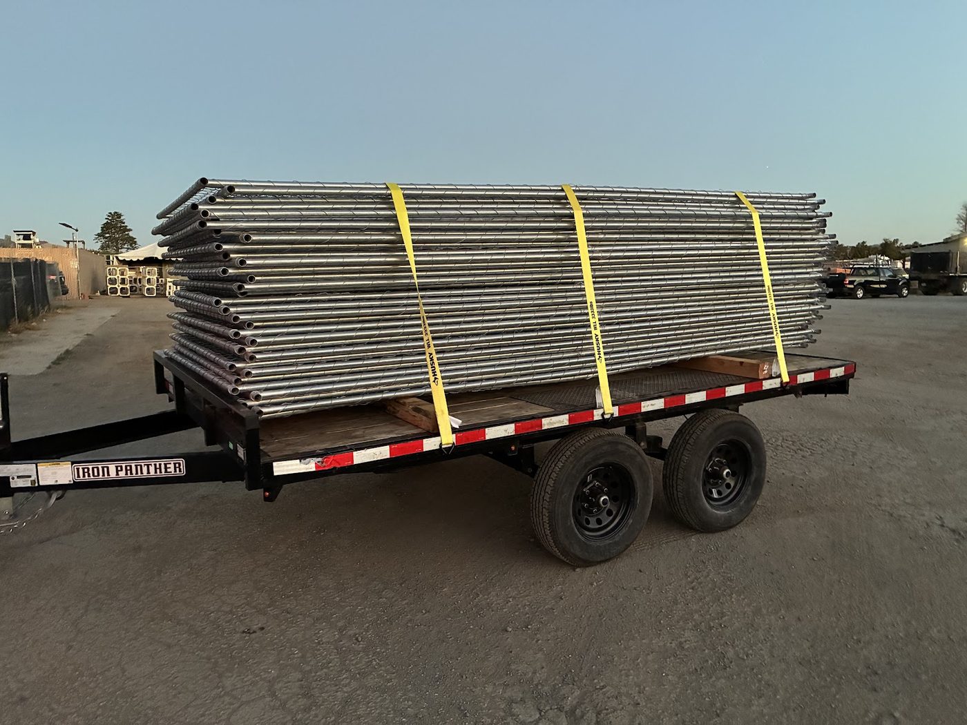 A flatbed trailer loaded with temporary fence panels ready for delivery